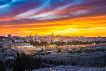 Fototapeta na wymiar Dramatic sunset clouds over Jerusalem: panoramic view of the Old and New City skyline, of the Temple Mount with the Dome of the Rock, of the eastern wall with Golden Gate, and of Kidron Valley