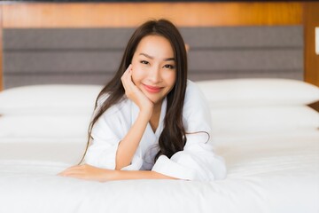 Portrait beautiful young asian woman relax smile on bed