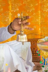 close up of the hand of a  balinese priest giving a blessing during a ceremony