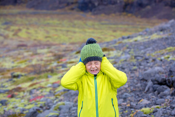 Child making funny face in beautiful Skaftafell Glacier national park on a gorgeous autumn day