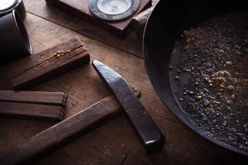 Finding gold. gold panning, digging or gold prospecting. Gold on wash pan with Gold prospecting tools.