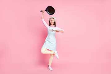Full length body size view of her she nice attractive pretty focused housewife holding in hands kitchenware utensil posing meditating asana yoga zen isolated over pink pastel color background - obrazy, fototapety, plakaty