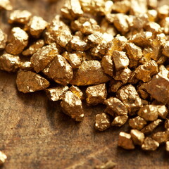 Mound of gold on a old wooden work table. Shallow depth of field.