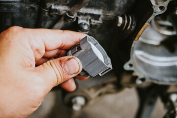 A working electrician is wiring during a motorcycle electrical installation.