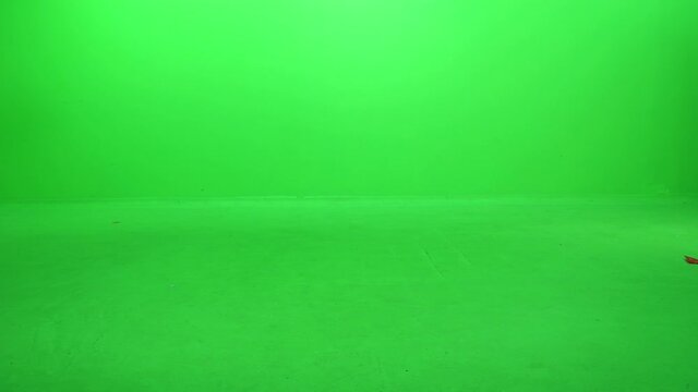 Excited little toddler runnnig from side to side, happy and cheerful, over green screen.