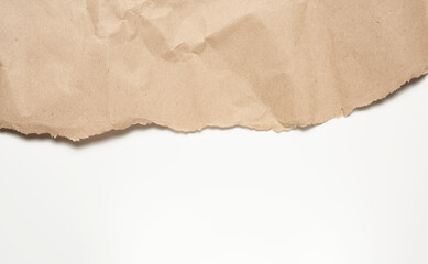 crumpled sheet of brown wrapping paper on a white background