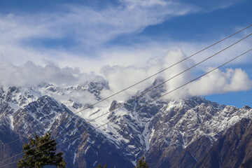 Top of a Mountains peaks through the clouds India