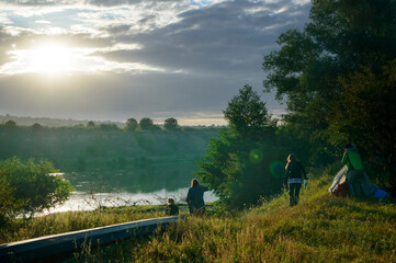 Tourist group in the early morning on the banks of the Dniester River.