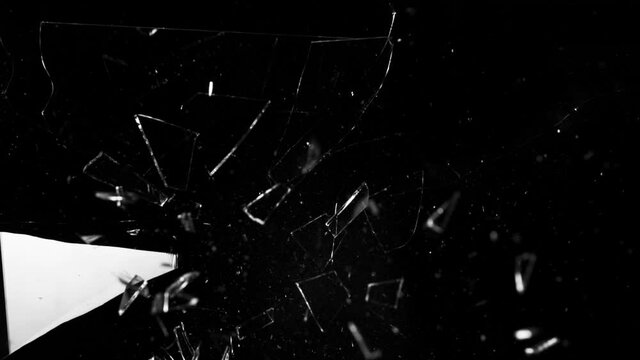 Super slow motion of shattered glass on black background. Filmed on high speed cinema camera, 1000 fps.