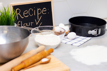 making dough for bread or homemade baked goods. ingredients on the table. recipe board