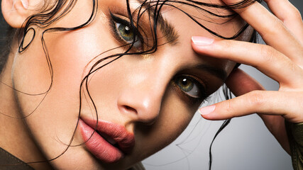 Fototapeta Closeup portrait of a beautiful young woman with brown gkamour makeup. Model looking at camera.. obraz