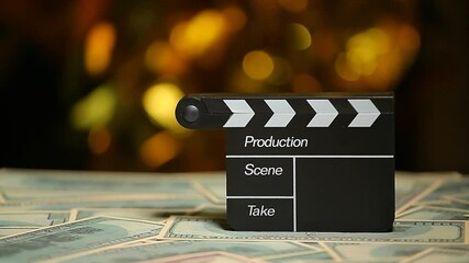 footage of clapper board money - Powered by Adobe