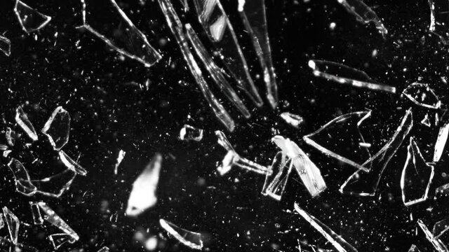 Super slow motion of shattered glass on black background. Filmed on high speed cinema camera, 1000 fps.