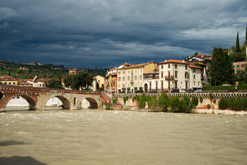 Fototapeta na wymiar Bridge over the river in Verona Italy Ponte Pietra dramatic weather Adige river