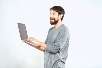 Bearded man with laptop in hands internet communication technology light background