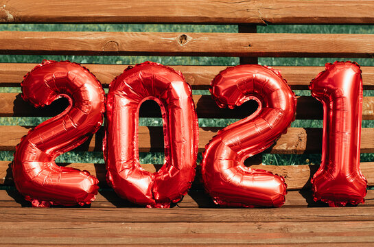 figures 2021 from balloons on wooden bench, the concept of new year and Christmas