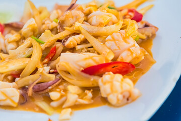 Stir-fried salted egg with squid on dish, traditional Thai food