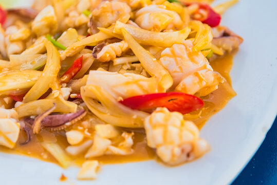 Stir-fried salted egg with squid on dish, traditional Thai food