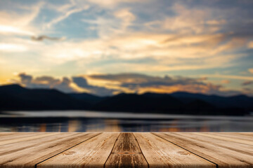 Naklejka na ściany i meble Showcase an old wooden table shelf on a beautiful sunset and blurred nature background.