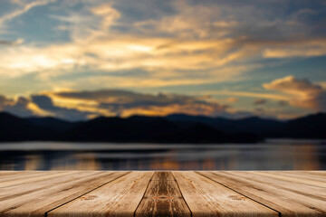 Naklejka na ściany i meble Showcase an old wooden table shelf on a beautiful sunset and blurred nature background.