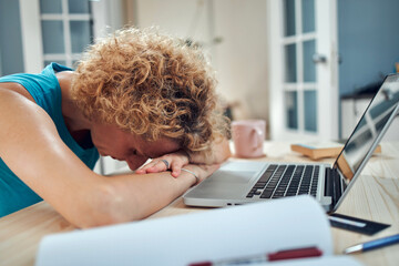 Woman sleeping on her desk at home while working remotely freelance job. Modern problems and issues...