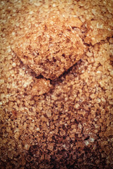Fragment of brown sugar cube on the crystalline sugar top view macro, copyspace