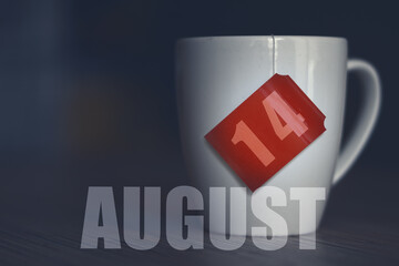 august 14th. Day 14 of month,Tea Cup with date on label from tea bag. summer month, day of the year concept