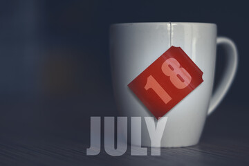 july 18th. Day 18 of month,Tea Cup with date on label from tea bag. summer month, day of the year concept
