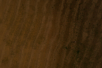 Aerial view from above. wavy field. brown earth. texture background.