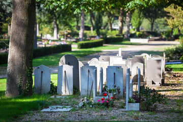 Tombstones with flowers on a cemetery in Rotterdam in the Netherlands