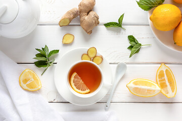 Antioxidant healthy tea with lemon, ginger and mint on a white wooden table. Alternative medicine concept.