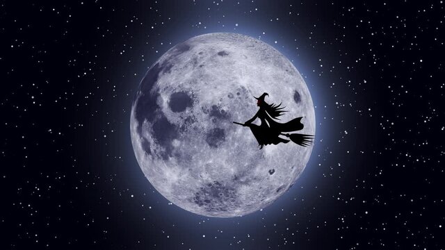 Halloween holiday. A witch on a broomstick flies against the background of the moon