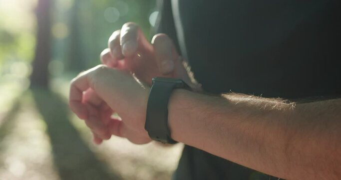 Man's hand touching a smart watch. Smart watch on a man's hand outdoor.