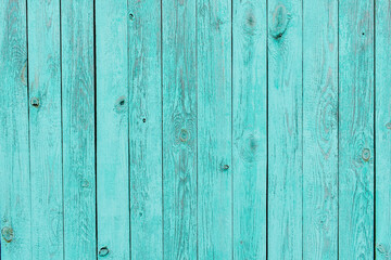 Texture of shabby wooden planks in blue. Peeling paint on wood grain surface. Old wooden background painted in turquoise colors. Wooden background.