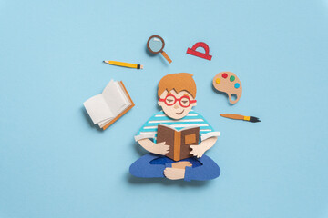 Smart schoolboy sitting in lotus pose with book. Illustration about education from paper on blue