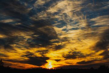 Colorful sunset with light and dark clouds.