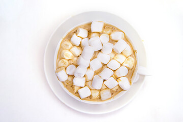 Coffee with marshmallows on a white background.Hot winter drink.