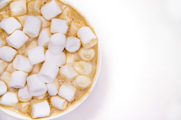 Coffee with marshmallows on a white background.Hot winter drink.