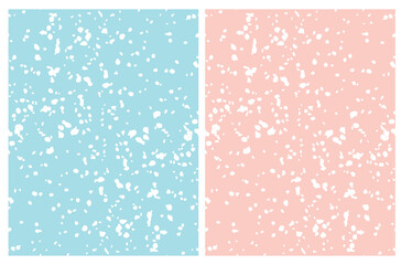 Cute Irregular Geometric Seamless Vector Patterns. White Hand Drawn Spots on a Light Blue and Pastel Pink Background. Winter Snowy Sky Print. 