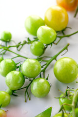 young green tomatoes, cucumbers and peas. Spiced vegetables. on white background.