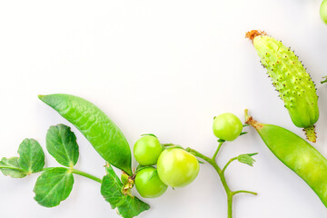 young green tomatoes, cucumbers and peas. Spiced vegetables. on white background.