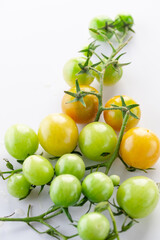 young green tomatoes, cucumbers and peas. Spiced vegetables. on white background.