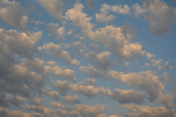 cumulus clouds on bright blue early Autumn sky
