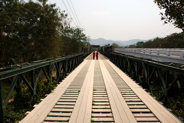 Thai people and foreign travelers travel visit and walking take photo on Tha Pai Memorial Bridge or...