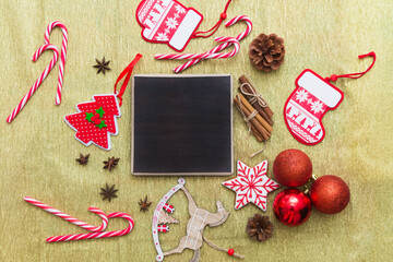 Merry Christmas golden flatlay background with gifts, Xmas balls, toys, sugar canes and black copy space.