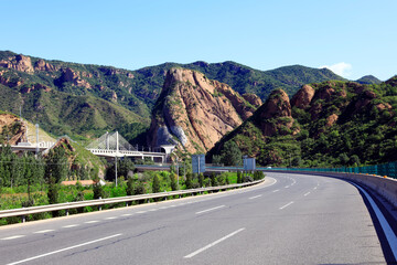 Empty highway, blue sky and white clouds landscape