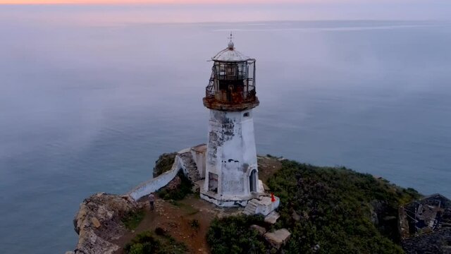 View from above. Flying over the Rudny lighthouse in the village of Rudnaya Pristan during dawn