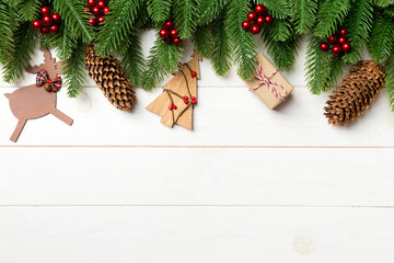 Fototapeta na wymiar Top view of fir tree and New Year decorations on wooden background. Christmas concept with copy space