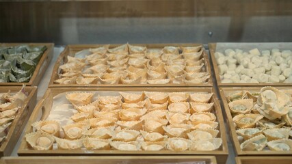 Tortellini on wooden trays at the italian restaurant kitchen, handmade italian food cooked. Lots of different tortellini prepared for restaurant meals
