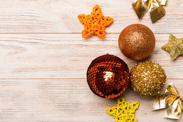 Creative set of New Year baubles and decorations on wooden background. Top view of Christmas time concept. Copy space